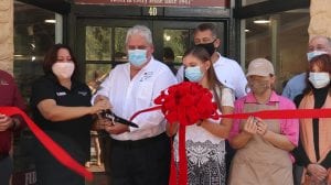 Krowicki family cut ribbon in front of Kilwins for soft opening.